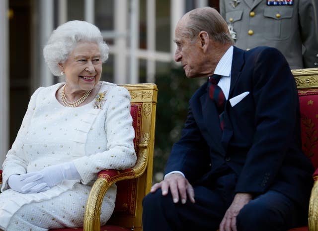 The Queen smiles at Philip