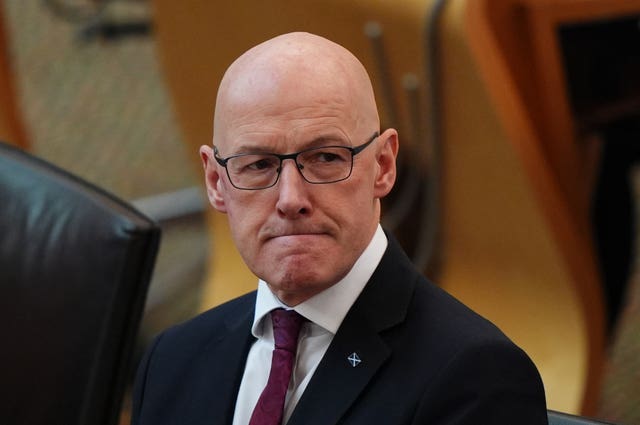 A close-up of John Swinney in a suit and tie