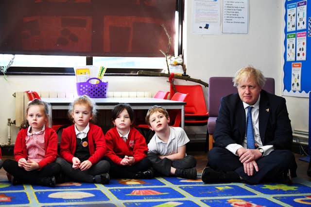 Before his Brexit event Boris Johnson visited a school to promote International Women's Day (Dylan Martinez/PA)