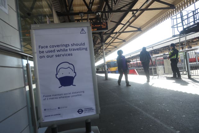 A sign advising passengers to wear a face mask at Clapham Junction station, London, as train services increase as part of the easing of coronavirus lockdown restrictions