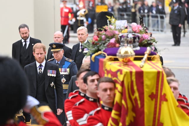 The Duke of Sussex watches as the coffin carrying the Queen arrives for her funeral