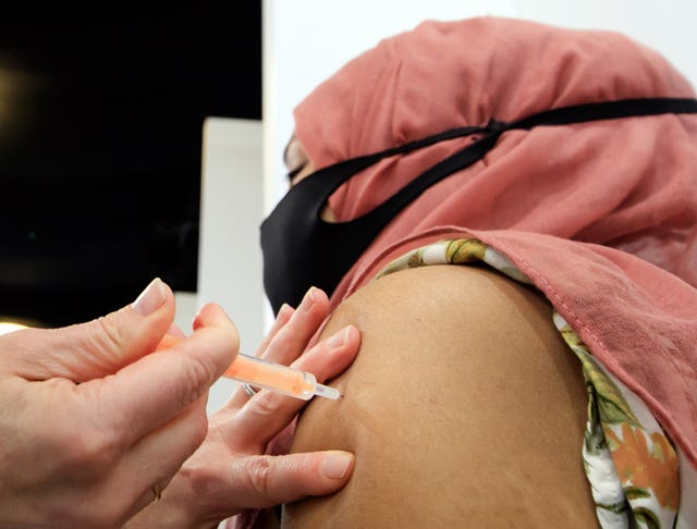 A woman receives an injection of the the Oxford/AstraZeneca coronavirus vaccine at Elland Road vaccine centre in Leeds (Danny Lawson/PA)