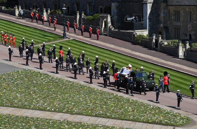 The Duke of Edinburgh’s coffin, covered with his Personal Standard, is carried on the purpose-built Land Rover Defender followed by the Princess Royal, the Prince of Wales, the Duke of York, the Earl of Wessex, the Duke of Cambridge, Peter Phillips, the Duke of Sussex, the Earl of Snowdon, Vice Admiral Sir Timothy Laurence outside St George’s Chapel, Windsor Castle