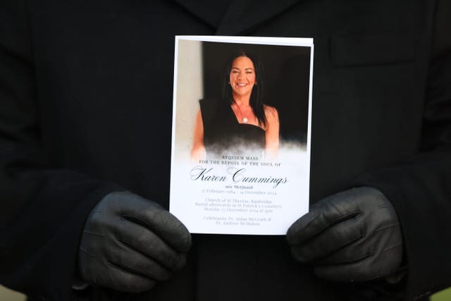 A mourner holds an Order of Service at the funeral of Karen Cummings