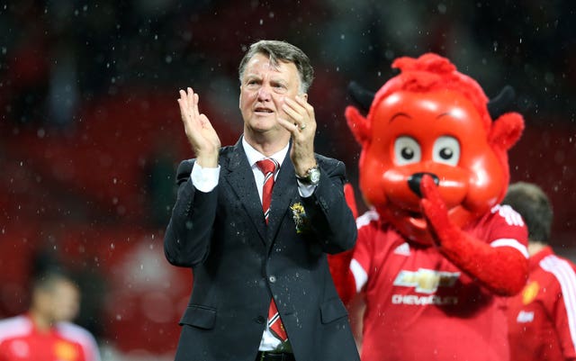 Louis van Gaal applauds the Manchester United fans alongside club mascot Fred the Red, right