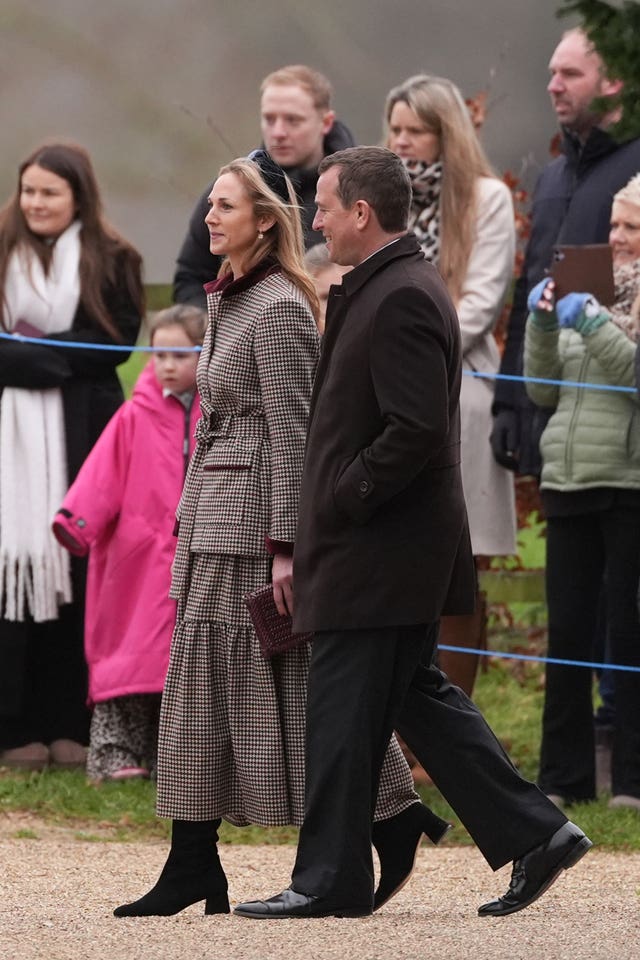 Harriet Sperling and Peter Phillips smiling while walking outside