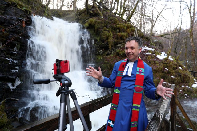 Minister recording outdoor sermon