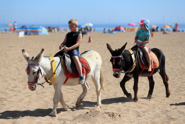 Children enjoy a donkey ride on Skegness Beach