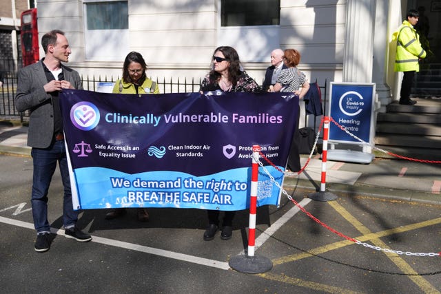 Clinically Vulnerable Families founder Lara Wong (right) and supporters hold a banner outside Dorland House following the publication of the report 