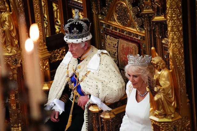 The King and Queen sit on thrones at the State Opening of Parliament