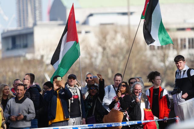 People holding Palestinian flags