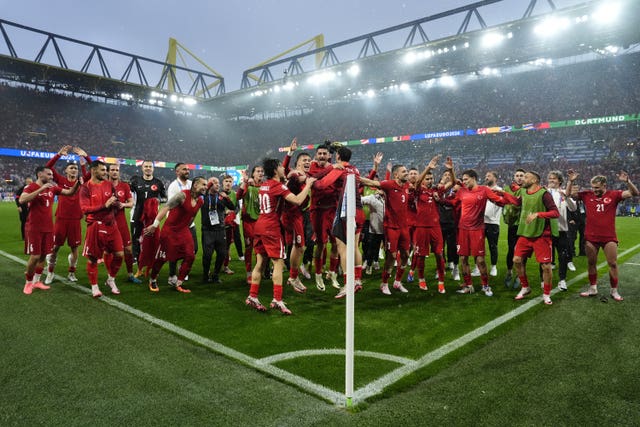 Turkey's squad celebrate in heavy rain after victory over Georgia