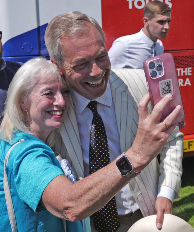 Reform UK leader Nigel Farage poses for a selfie