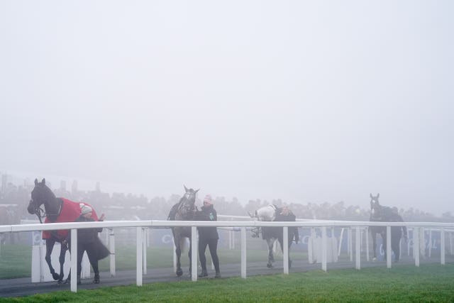 Horses in the parade ring as heavy fog surrounds them during The Coral Welsh Grand National at Chepstow Racecourse. 