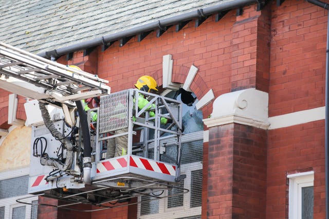 Merseyside Fire & Rescue service help repair a broken window at Southport Islamic Centre Mosque in Southport