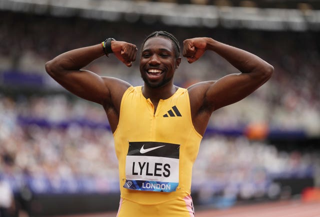 World champion Noah Lyles flexes both arms at the London Diamond League meet