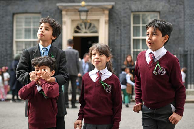 Schoolchildren attend a Green for Grenfell reception hosted by Theresa May (Victoria Jones/PA)