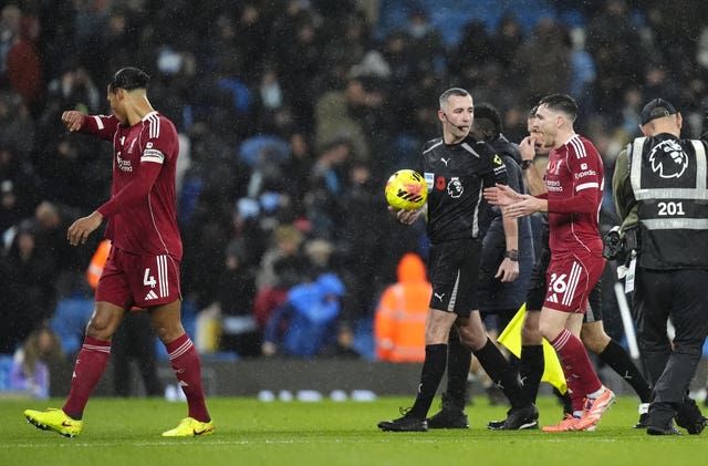 Liverpool’s Andrew Robertson speaks with referee Chris Kavanagh about a decision at Manchester City