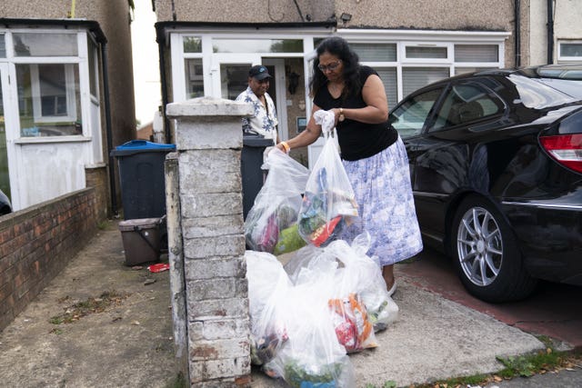 Residents Rose and Kes Bala dispose of spoiled food