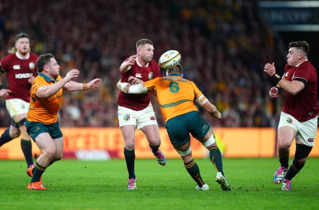 British and Irish Lions’ Finn Russell offloads the ball under pressure