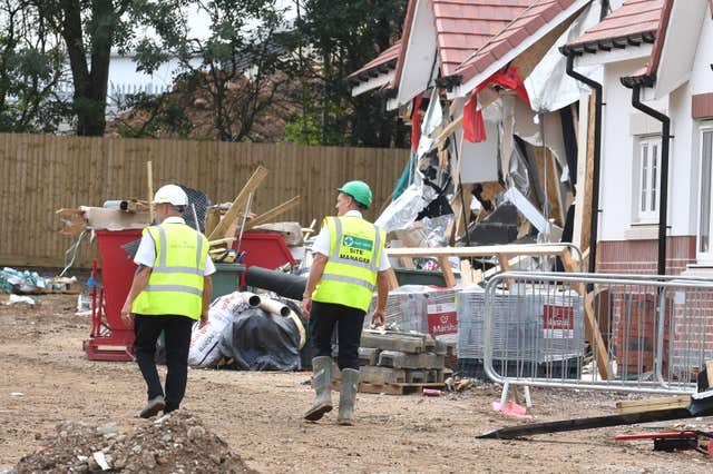 Site staff inspect damaged properties