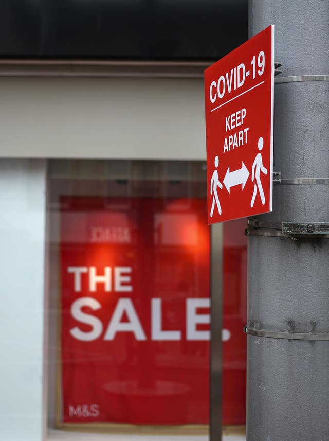 A social distancing information sign in front of a Marks and Spencer shop window advertising a sale in Reading, Berkshire, some six months on from the evening of March 23, when Prime Minister Boris Johnson announced nationwide restrictions