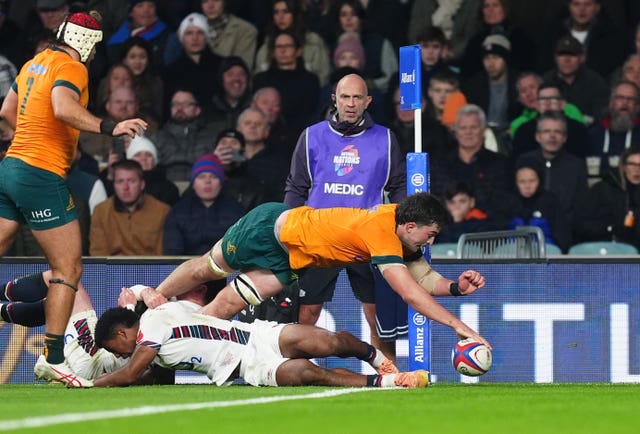 Australia’s Jeremy Williams, right, stretches over the England defence to score