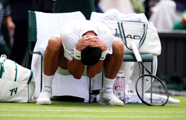Novak Djokovic stretches in-between games