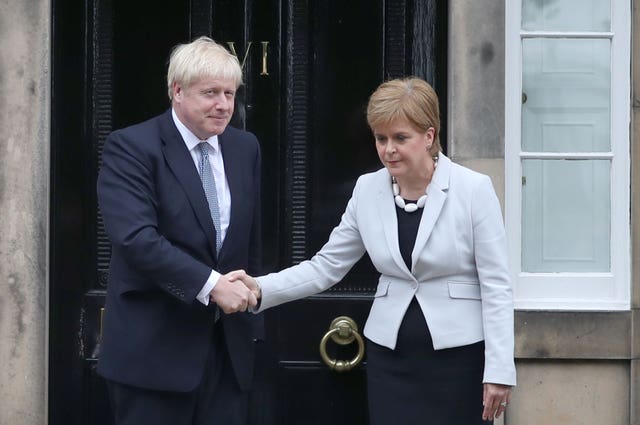 Boris Johnson and Nicola Sturgeon awkwardly shaking hands outside Bute House