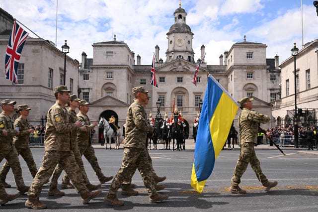 Ukrainian soldiers march past Horse Guards on Whitehall during a parade to mark 80 years since VE Day