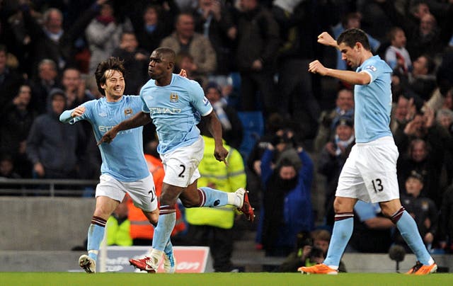 Micah Richards, centre, celebrates scoring a goal