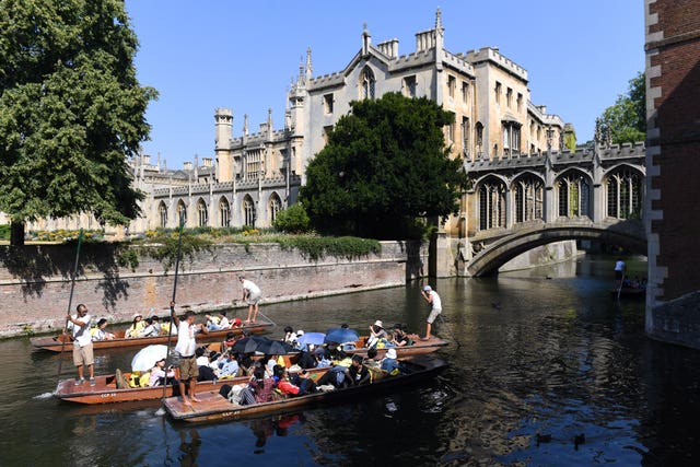 People punt under the Bridge of Sighs at St John’s College in Cambridge on the River Cam