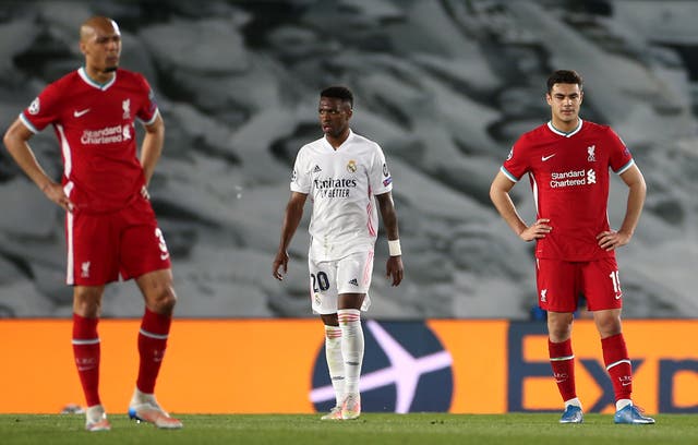 Liverpool’s Fabinho (left) and Ozan Kabak appear dejected after conceding against Real Madrid