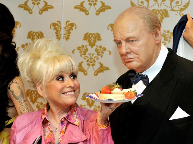 Barbara Windsor offers the wax figure of Sir Winston Churchill some lunch at Madame Tussauds