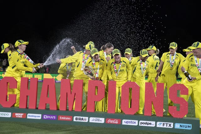Australia celebrate their World Cup win behind a 'Champions' banner