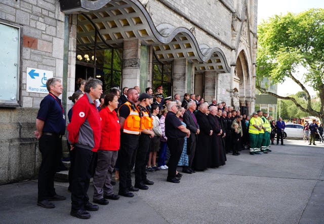 People gathered outside the Guildhall in Plymouth to hold a minute's silence to the victims (Ben Birchall/PA)
