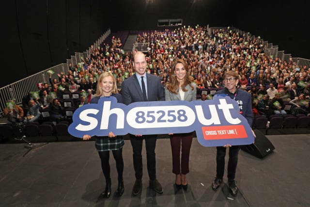 William and Kate on a London theatre stage during a volunteer celebration event with the text helpline Shout. Yui Mok/PA 