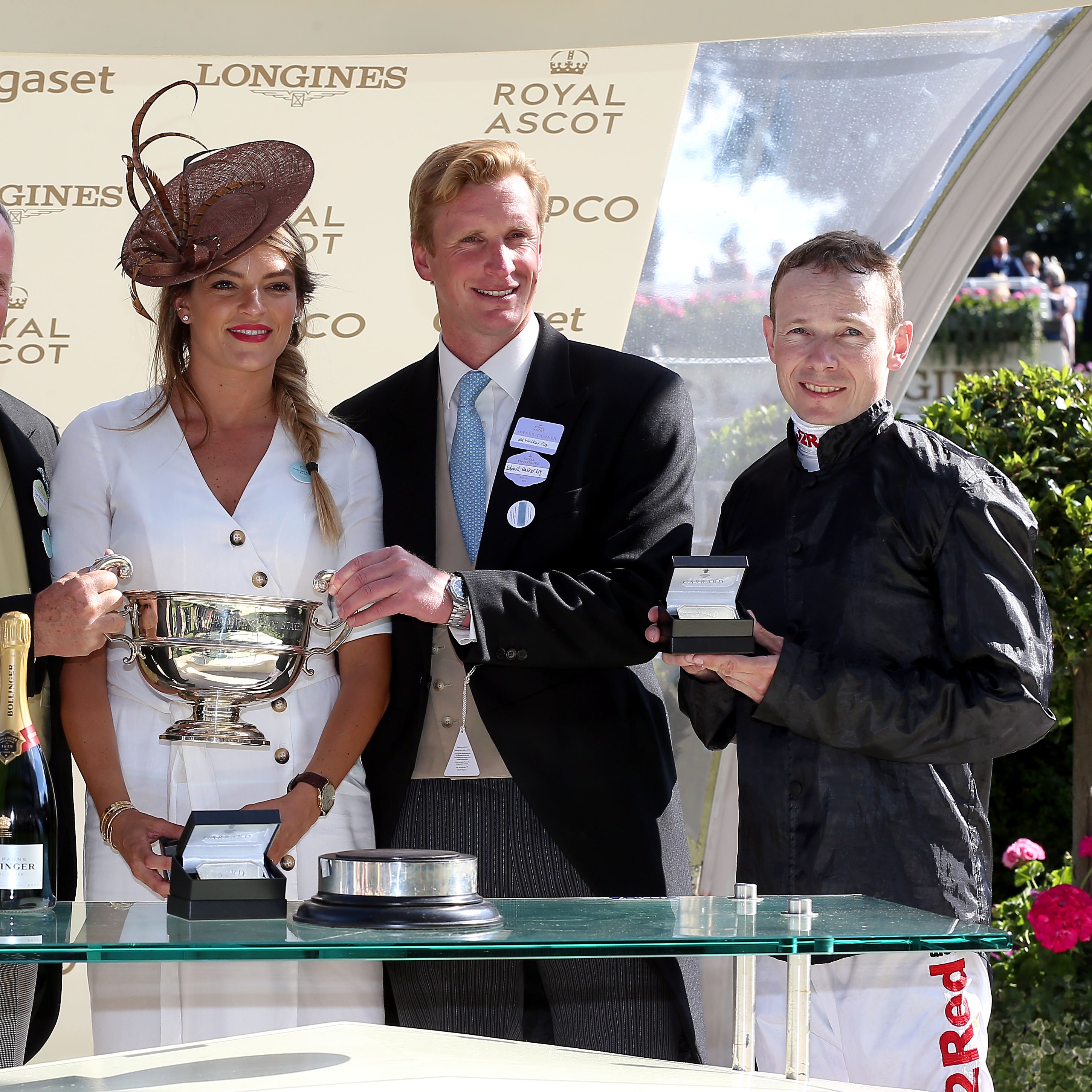 Jockey Jamie Spencer, owner Bjorn Nielsen and trainer Ed Walker receive their trophies after winning the Sandringham Stakes with Agrotera