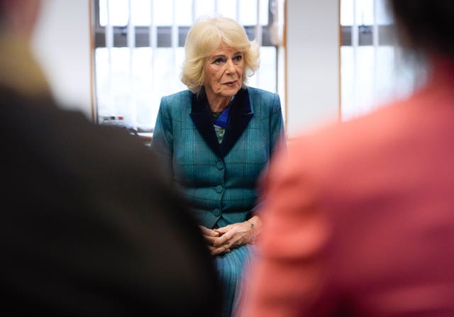 The Queen viewed from the backs of two people sitting opposite her