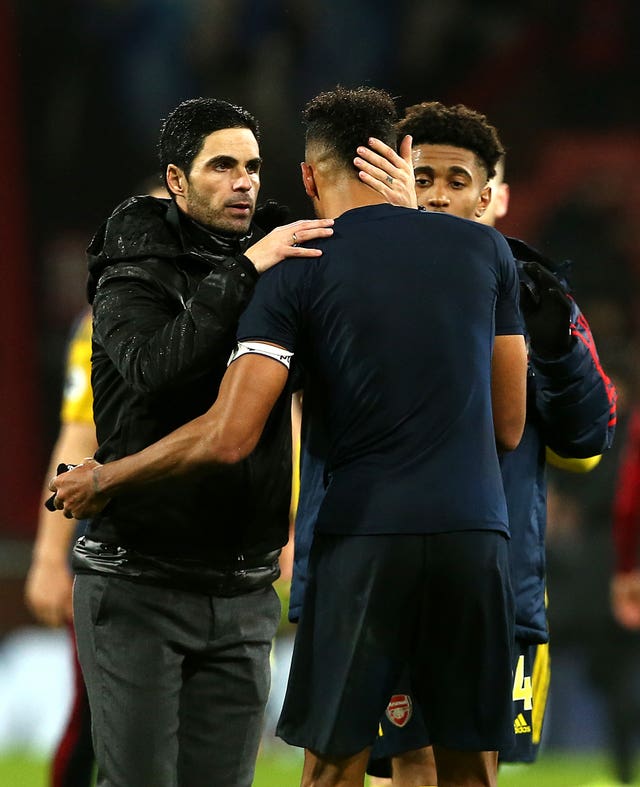 Mikel Arteta, left, embraces Pierre-Emerick Aubameyang after Arsenal's draw at Bournemouth