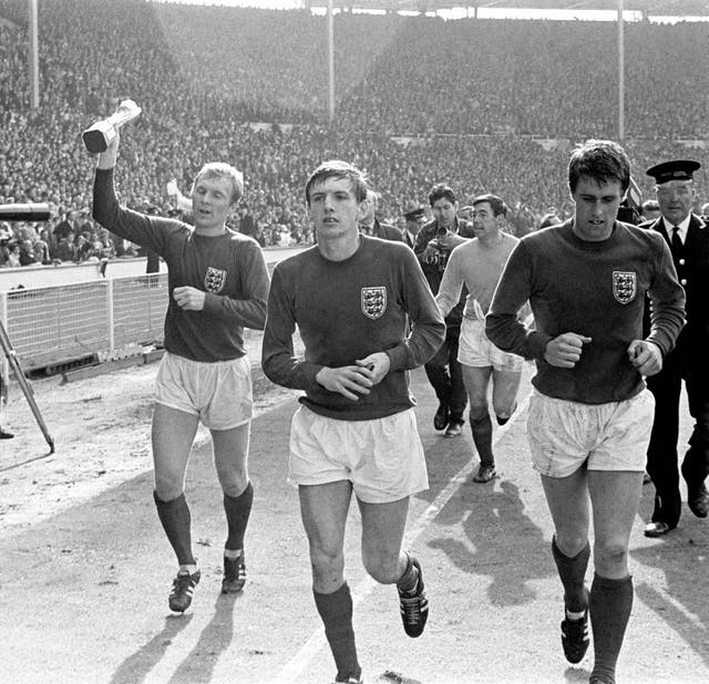West Ham players Bobby Moore, Martin Peters and Geoff Hurst during the England team’s lap of honour at Wembley following the 1966 World Cup final