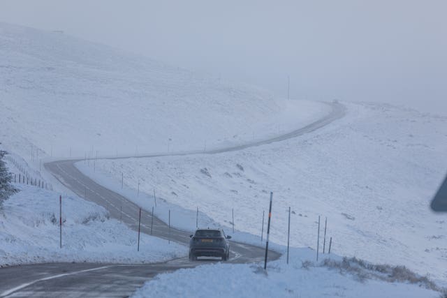 A car makes its way along the A939 after heavy snowfall in the Cairngorms, Scottish Highlands