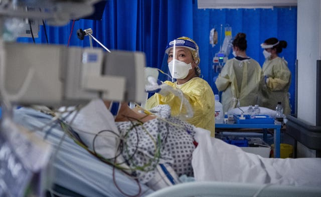 A nurse works on a patient in the Intensive Care Unit