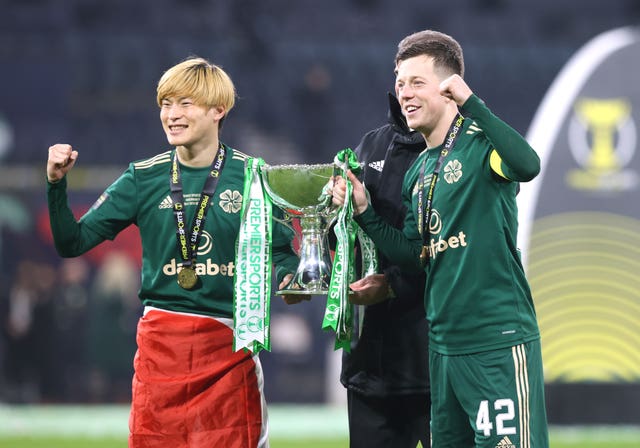 Kyogo Furuhashi, left, lifts the trophy