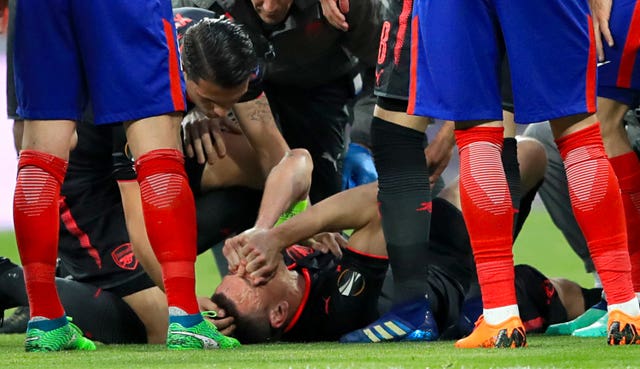Arsenal skipper Laurent Koscielny was carried off on a stretcher following an early injury