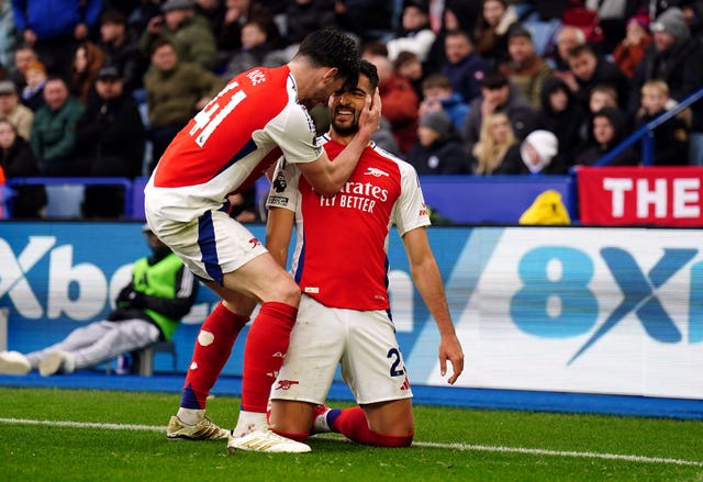 Arsenal’s Mikel Merino slides on his knees and is grabbed by Declan Rice in the corner of the pitch after the side's first goal at Leicester.