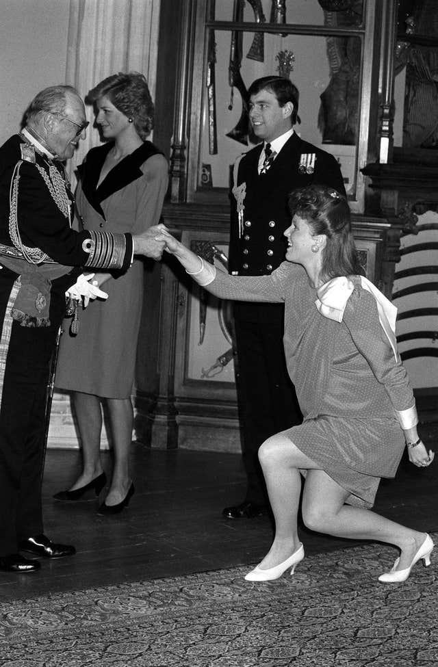 Sarah, Duchess of York has a similar curtsying style as the prime minister and is pictured here greeting King Olav of Norway at Windsor Castle in 1988. (PA)