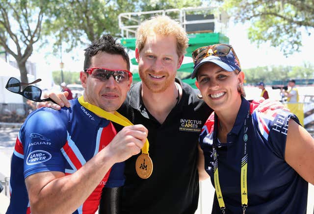 Jaco van Gass, left, celebrates with Invictus Games founder Prince Harry, centre, at the 2016 event