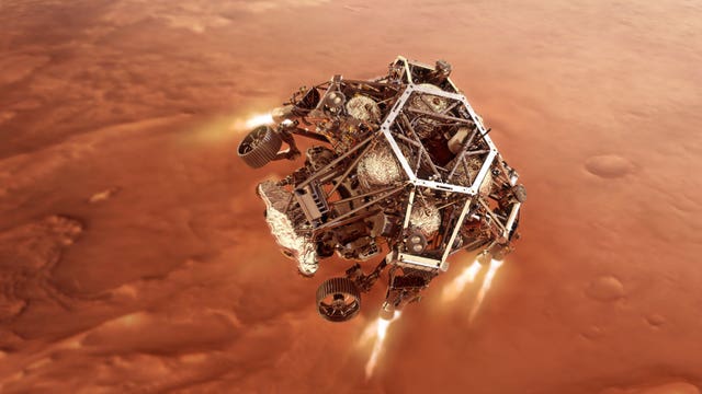 Undated handout artist impression issued by NASA of NASA's Perseverance rover firing up its descent stage engines as it nears the Martian surface