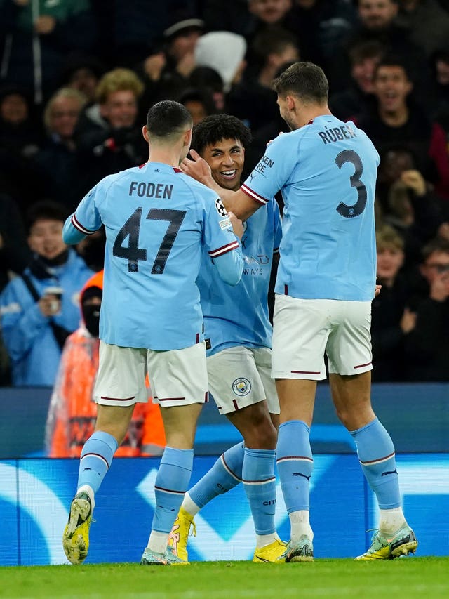 Rico Lewis , centre, celebrates scoring with fellow academy graduate Phil Foden, left